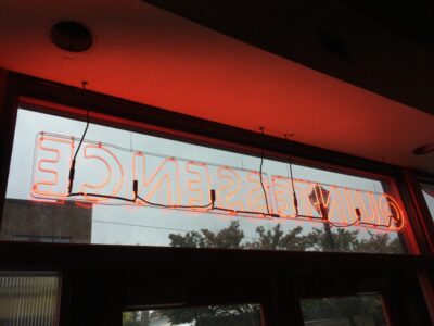 Neon sign hung in window, from the back